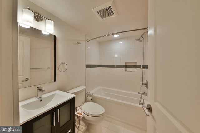 full bathroom featuring tiled shower / bath, vanity, toilet, and tile patterned floors