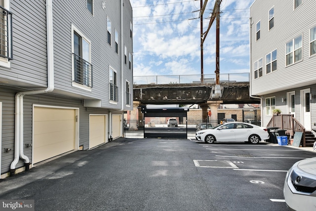 view of parking / parking lot featuring a garage