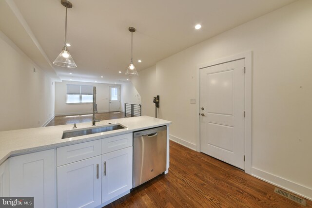 kitchen featuring dark wood-type flooring, white cabinets, dishwasher, pendant lighting, and sink