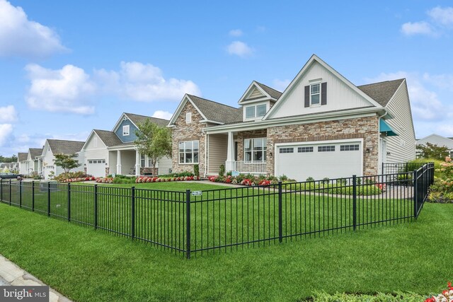 view of front facade featuring a front yard, a garage, and a porch