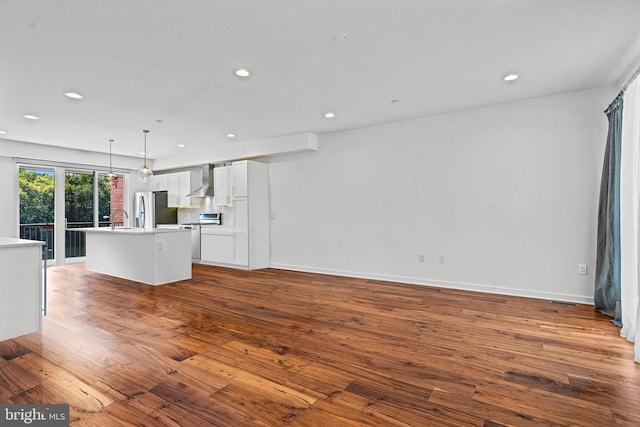 unfurnished living room with sink and hardwood / wood-style floors