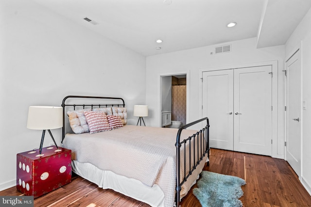 bedroom with wood-type flooring and a closet