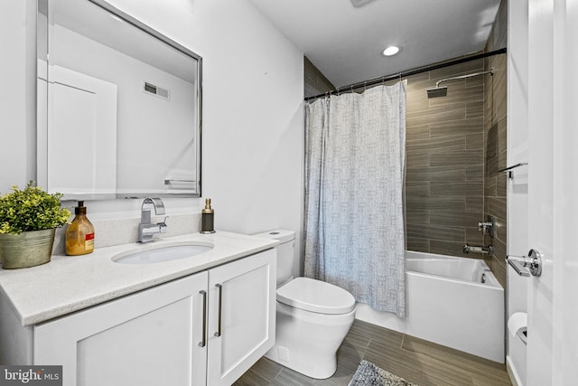 full bathroom with wood-type flooring, vanity, toilet, and shower / bath combo with shower curtain