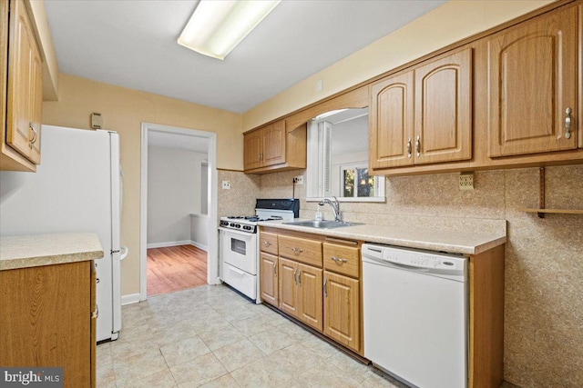 kitchen featuring white appliances and sink