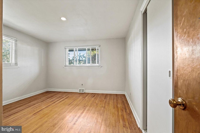 unfurnished room with wood-type flooring and plenty of natural light