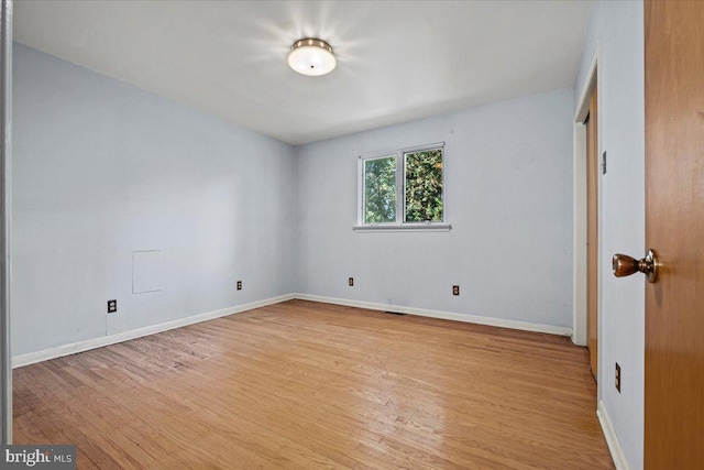 spare room with light hardwood / wood-style floors