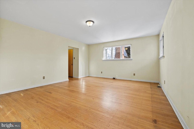 empty room with light hardwood / wood-style flooring