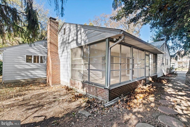 view of side of home featuring a sunroom