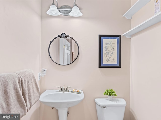 bathroom featuring toilet and sink