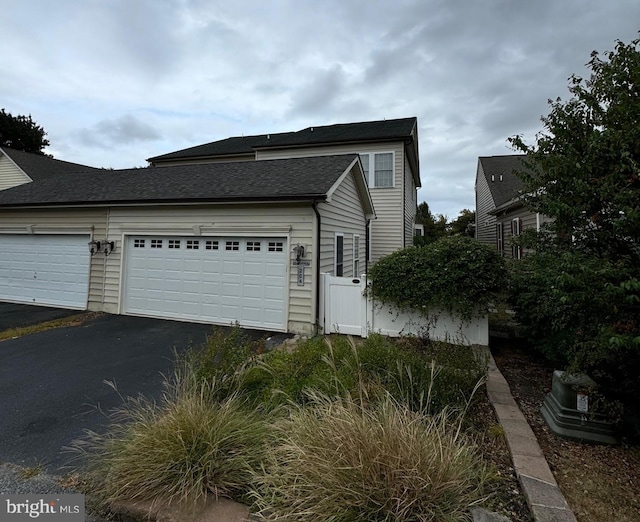 view of side of property with a garage