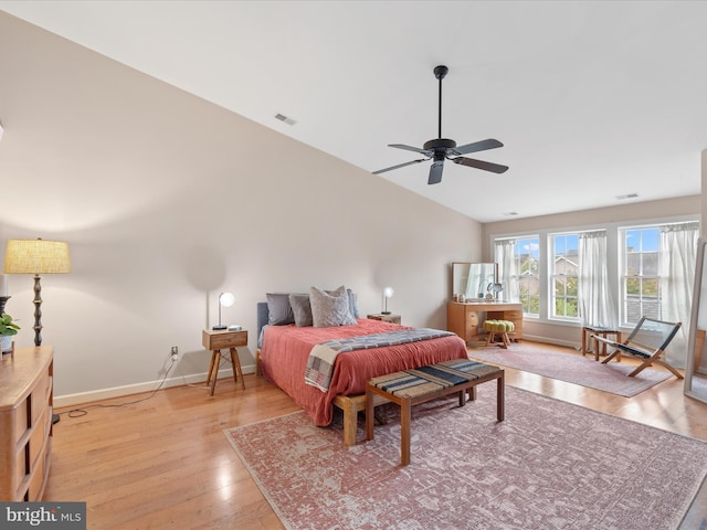 bedroom featuring ceiling fan, light wood-type flooring, and vaulted ceiling