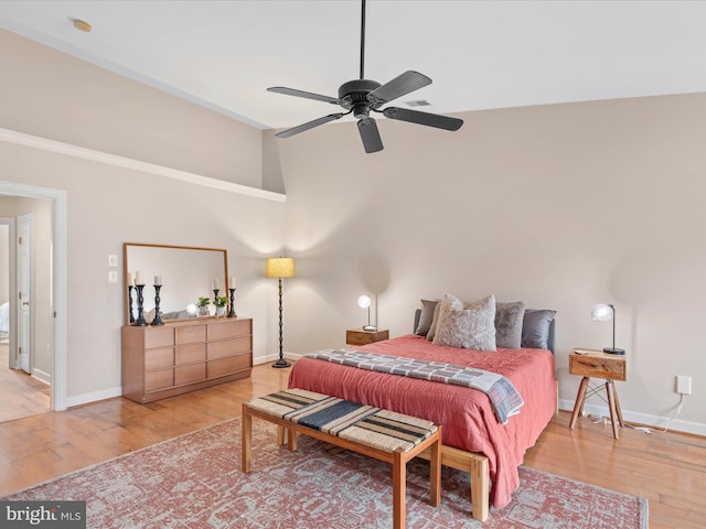 bedroom featuring wood-type flooring, high vaulted ceiling, and ceiling fan