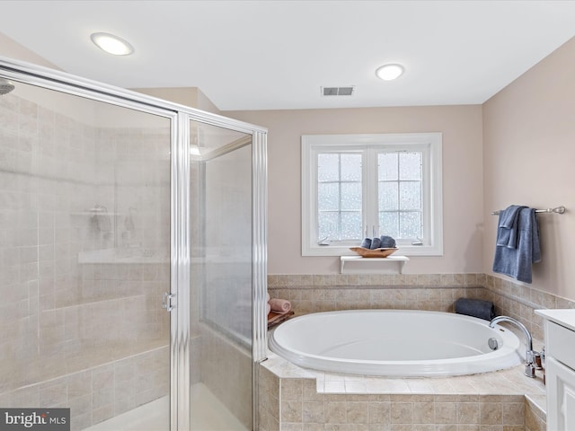 bathroom featuring independent shower and bath and vanity