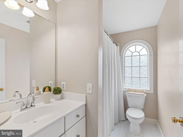 bathroom featuring vanity, tile patterned flooring, and toilet