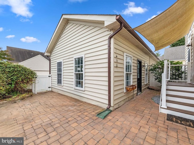 view of side of home with a patio