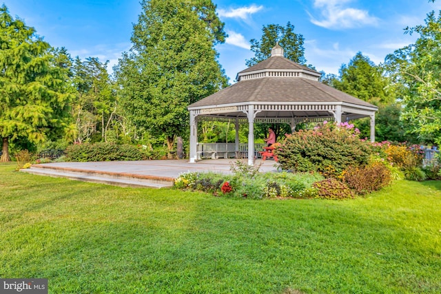 view of property's community with a patio area, a gazebo, and a yard