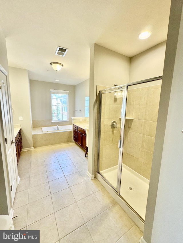 bathroom featuring tile patterned floors, separate shower and tub, and vanity