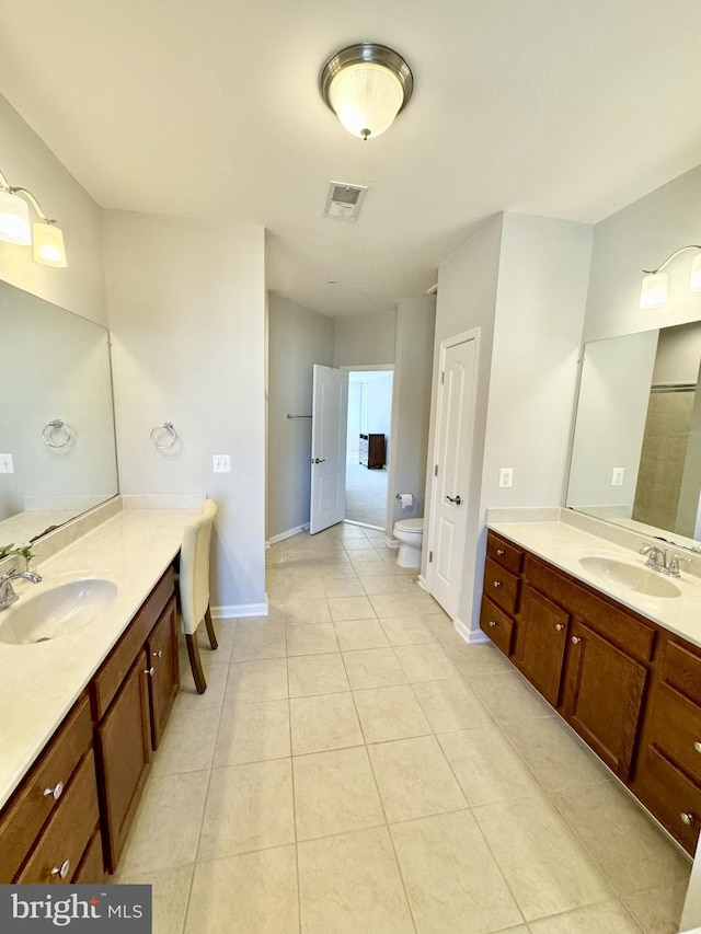 bathroom with a shower, tile patterned flooring, toilet, and vanity