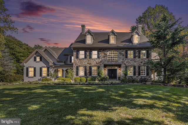 colonial home with a yard