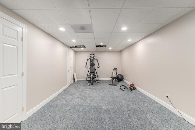 workout room featuring carpet floors and a paneled ceiling