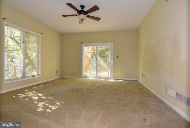 empty room featuring carpet and ceiling fan