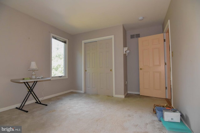 unfurnished bedroom featuring a closet and carpet floors