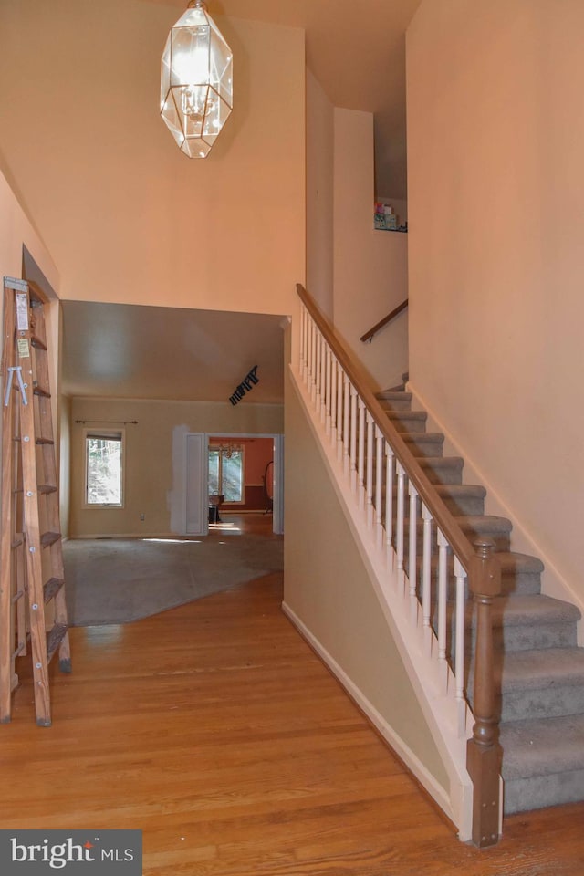 entrance foyer featuring hardwood / wood-style floors and a chandelier