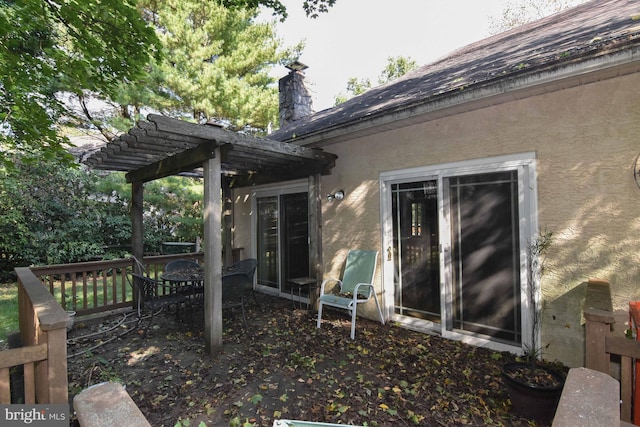 view of side of property with a pergola