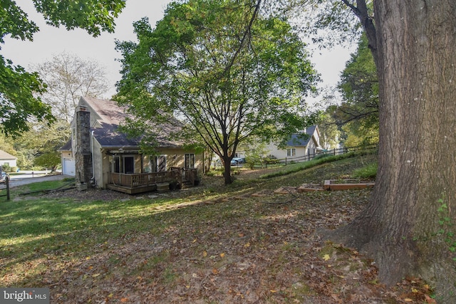 view of yard with a garage and a deck