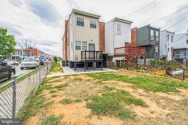 back of house featuring a wooden deck