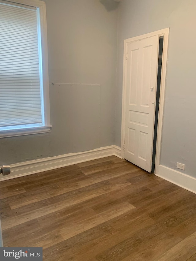 empty room with dark wood-type flooring