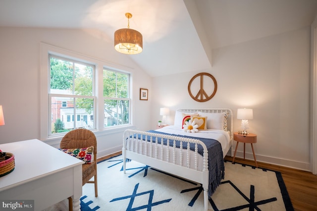 bedroom featuring lofted ceiling and hardwood / wood-style floors