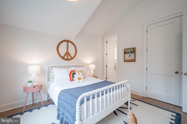 bedroom featuring light wood-type flooring and lofted ceiling