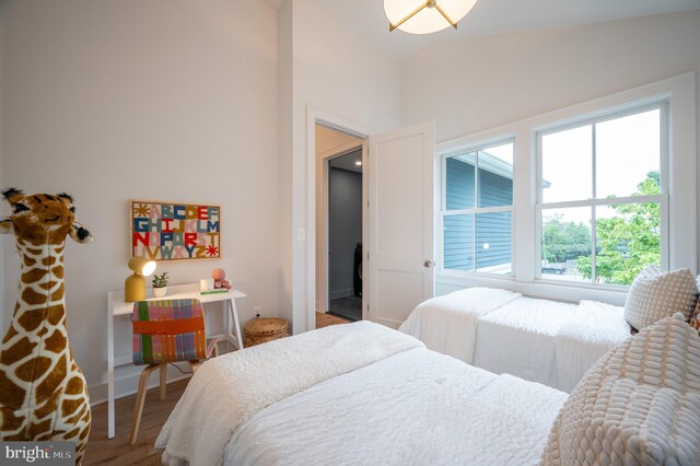 bedroom featuring wood-type flooring and lofted ceiling