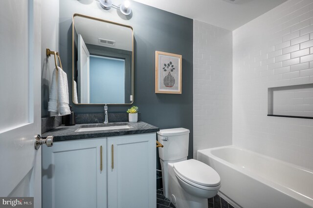 full bathroom featuring vanity, toilet, tile patterned floors, and tiled shower / bath