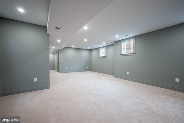 basement featuring light carpet