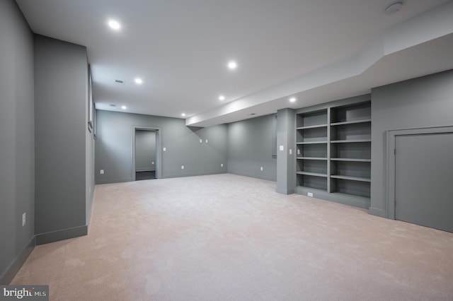 basement with light carpet and built in features