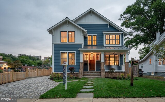 view of front of home with a porch and a front lawn