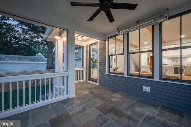 unfurnished sunroom featuring ceiling fan and wooden ceiling