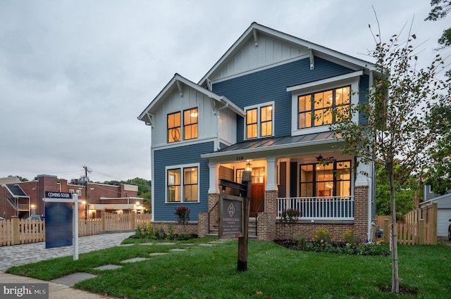 view of front of house with a front yard and a porch