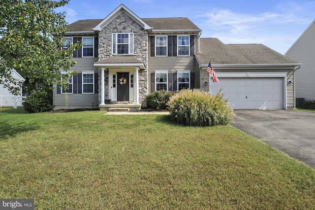 colonial-style house with a garage and a front yard