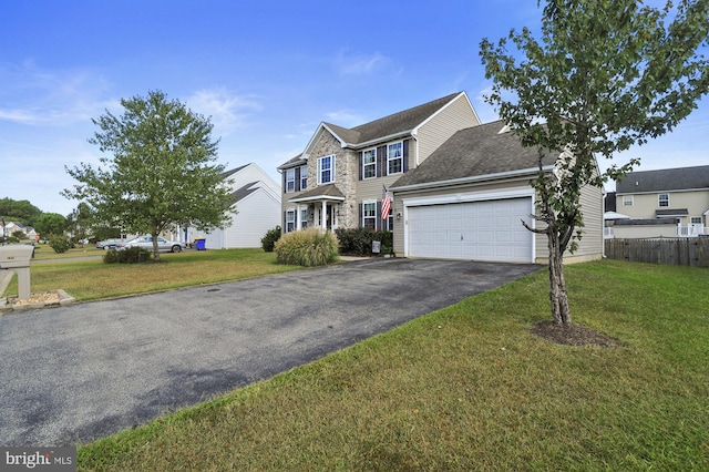 view of front of house featuring a garage and a front yard