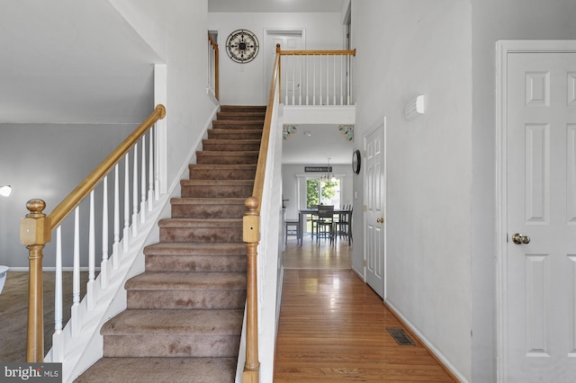 stairway with hardwood / wood-style floors