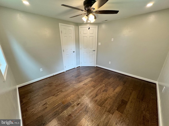 unfurnished bedroom featuring dark hardwood / wood-style flooring and ceiling fan