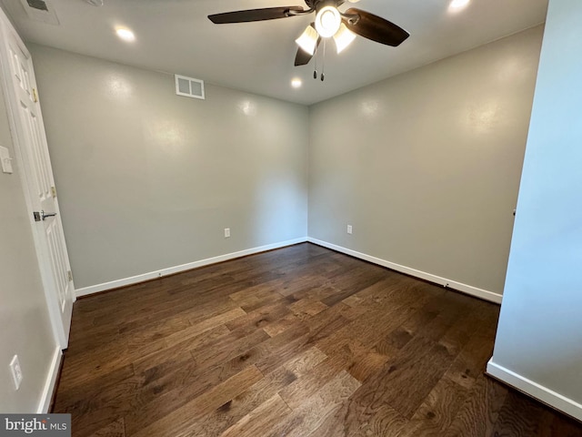 empty room featuring dark wood-type flooring and ceiling fan