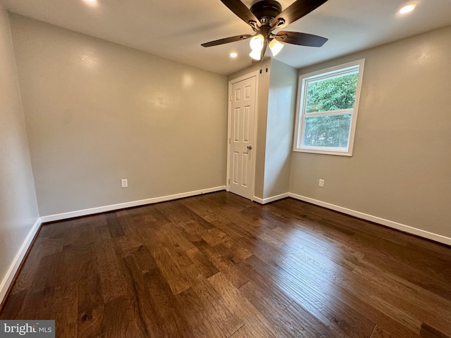 empty room featuring ceiling fan and dark hardwood / wood-style flooring