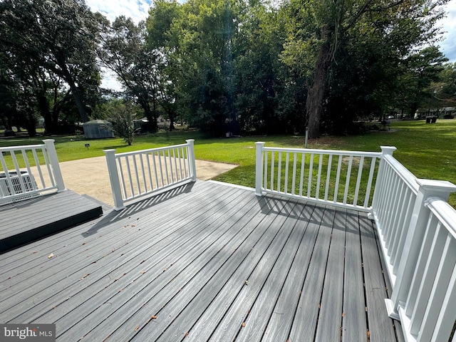 wooden deck featuring a lawn