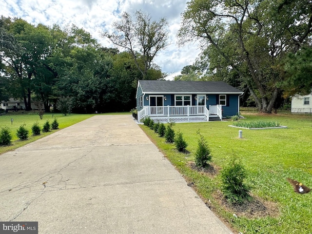 single story home with a front lawn and covered porch