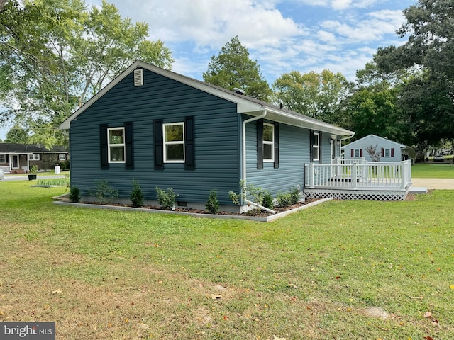 view of front of property with a wooden deck and a front lawn