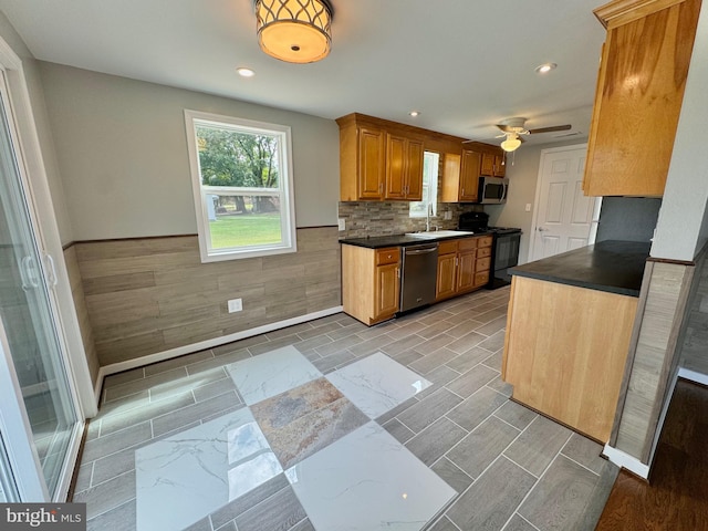 kitchen featuring ceiling fan, stainless steel appliances, decorative backsplash, and sink